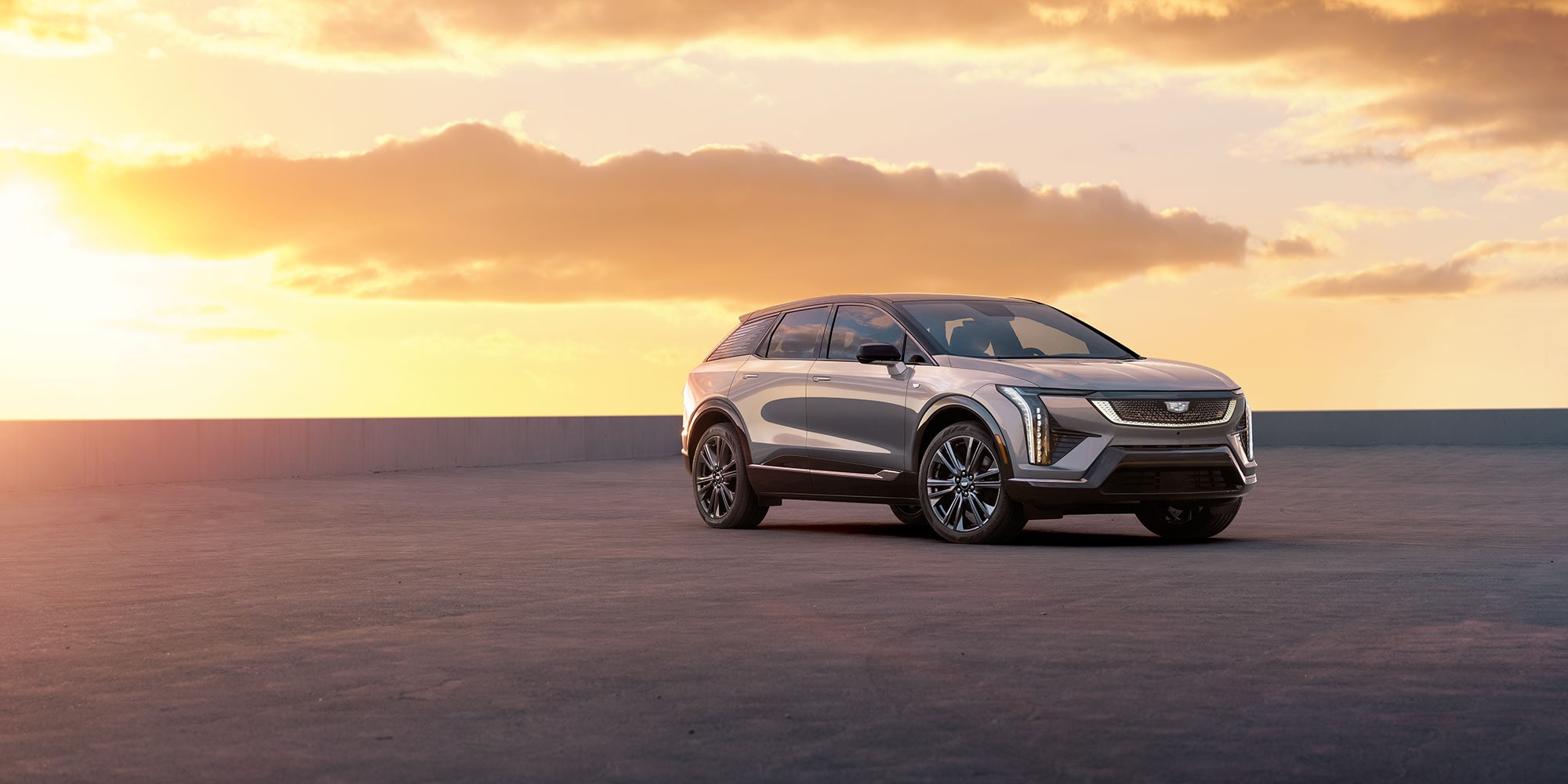 2025 Cadillac OPTIQ parked on rooftop at sunset.