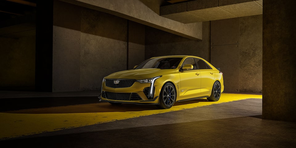 Three-quarters View of a Yellow    Cadillac CT4-V Parked in Parking Garage