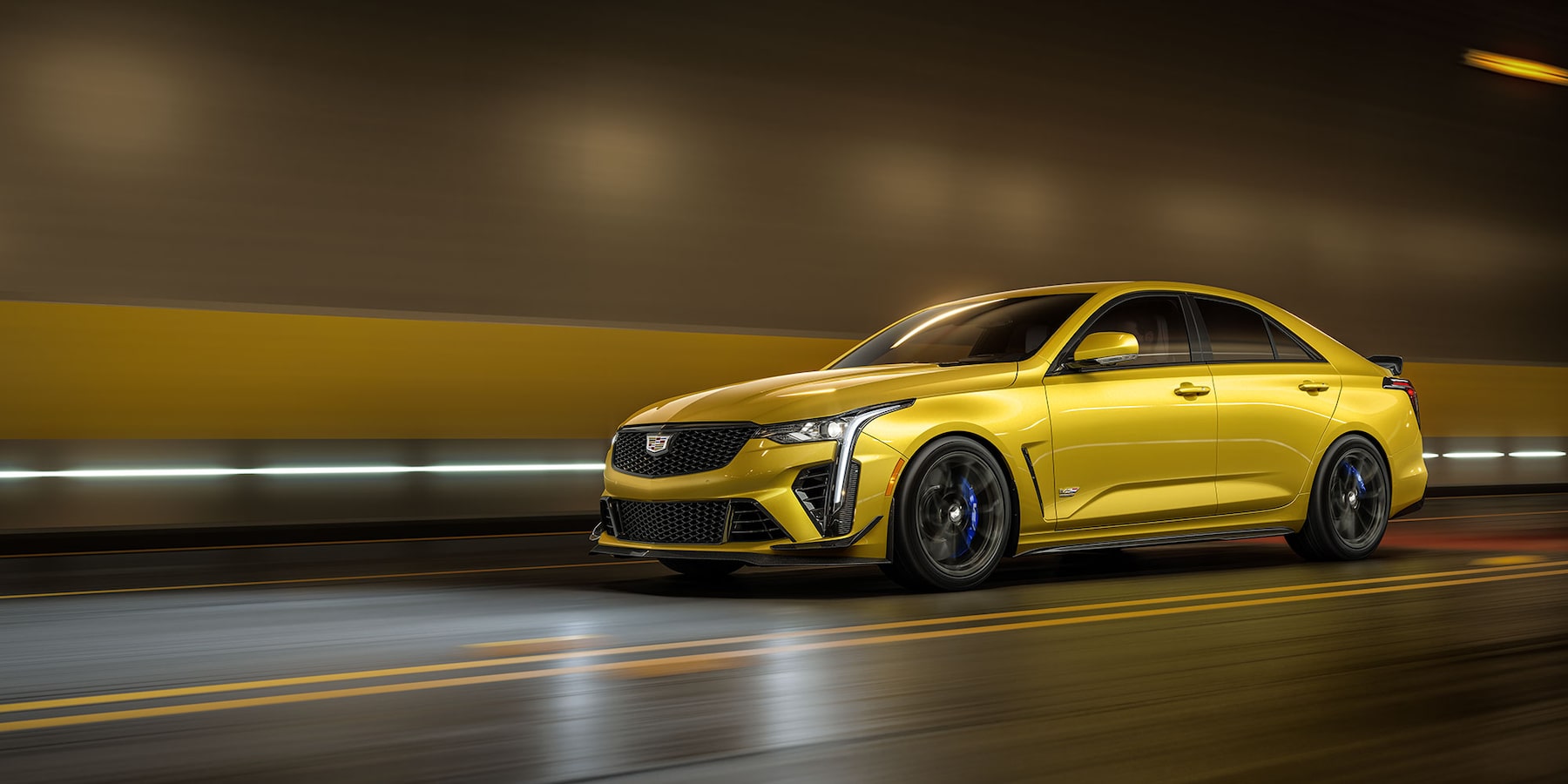 2025 Cadillac CT4-V in Yellow driving through underground tunnel.