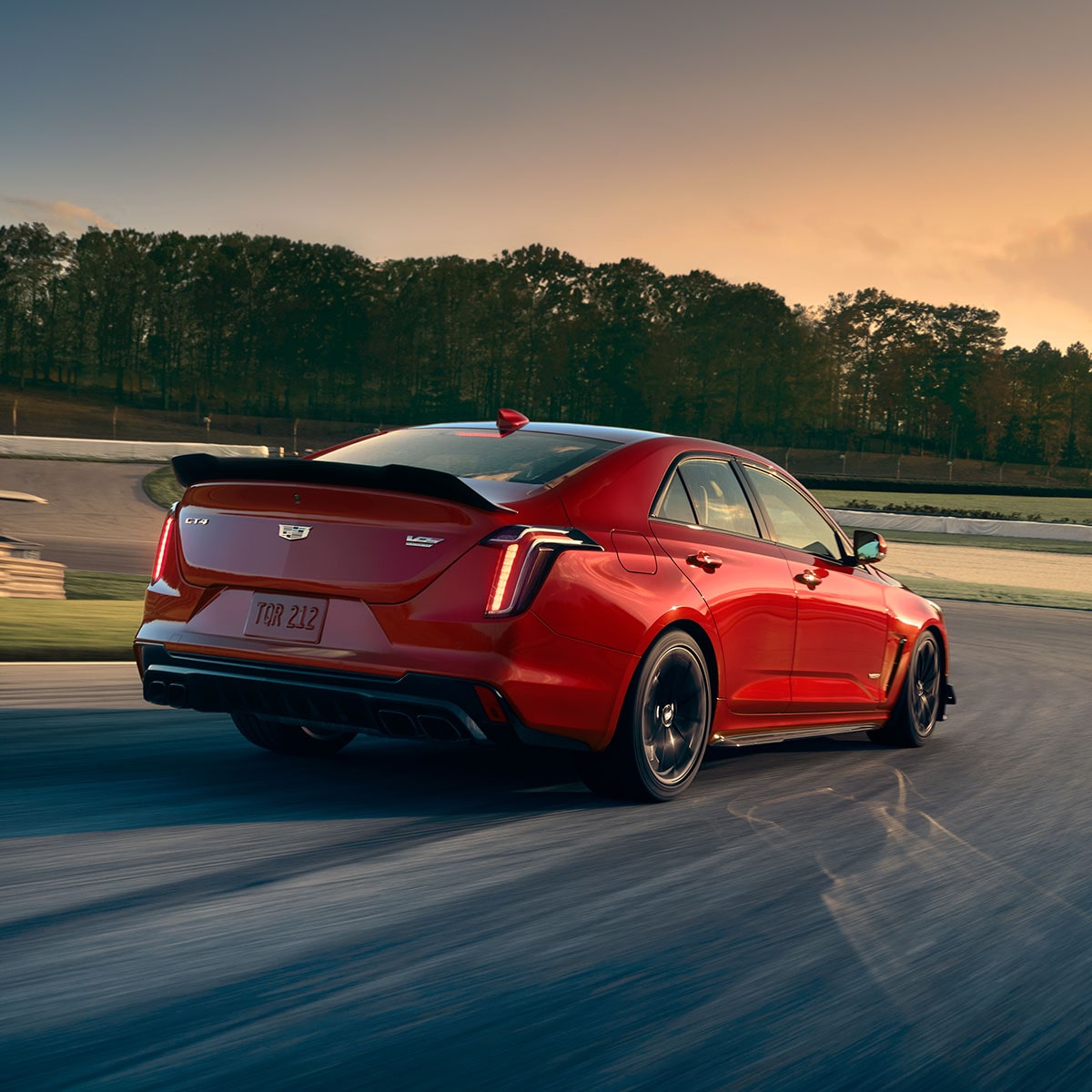 Rear View of a Red 2025 CT4-V Speeding Down a Racetrack