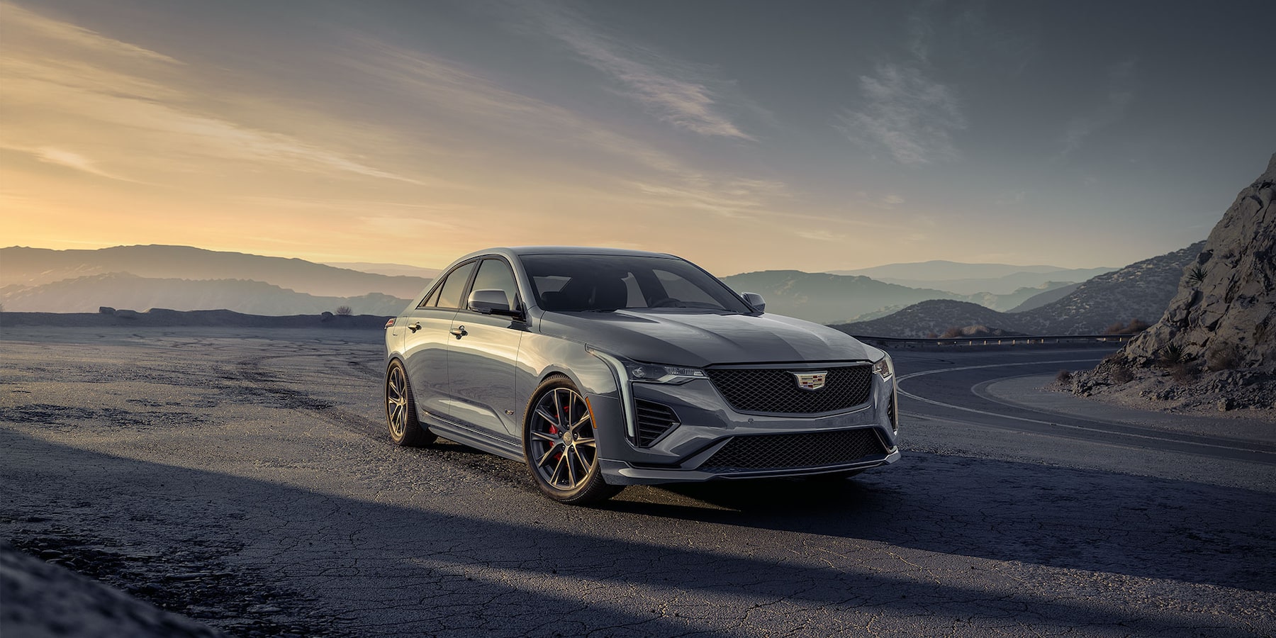 2025 Silver Cadillac CT4-V driving on coastal interstate.