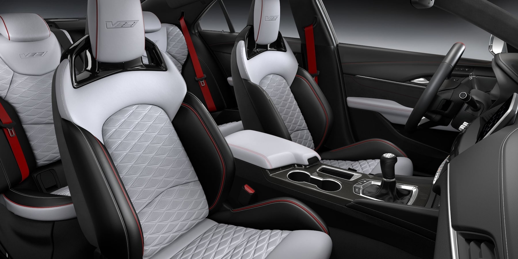 2025 Cadillac CT4-V quilted white interior and carbon fiber accented dashboard.