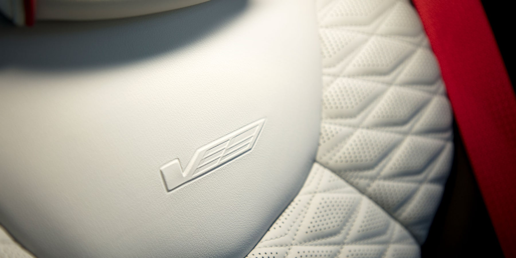 CT-4 V Embossed Cadillac V logo on white leather bucket seats