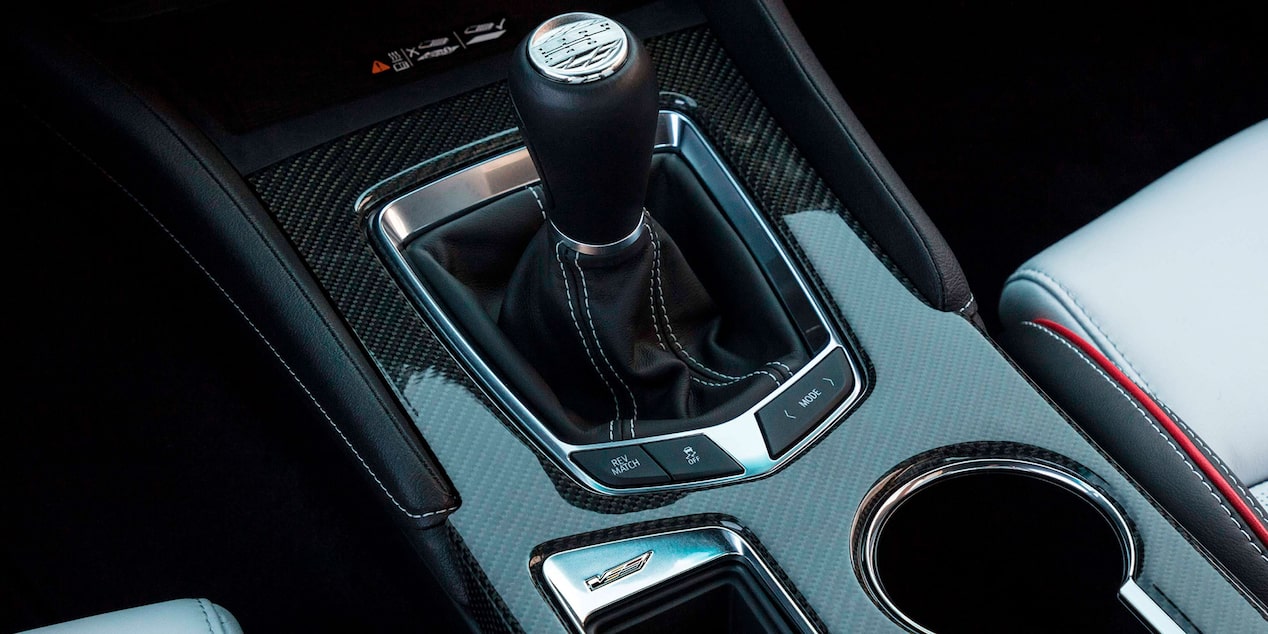 Manuel gear shifter with carbon fiber accented bezels and rev match button