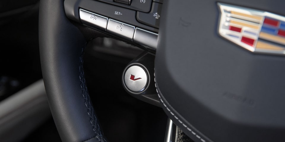 Close-up of the V Button on the CT4-V Sport Sedan Steering Wheel