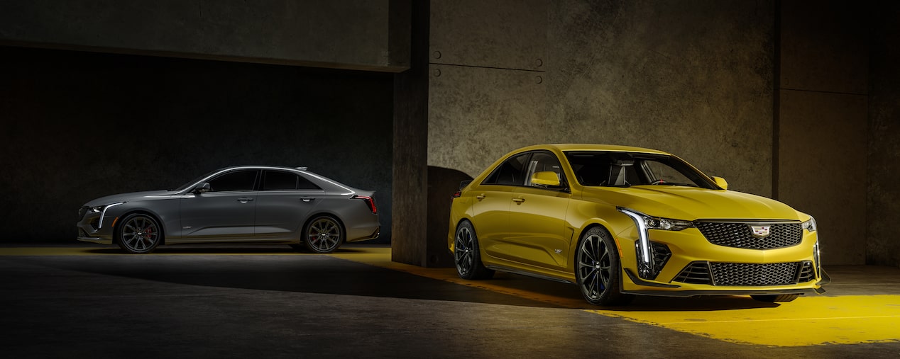 A Silver 2025 CT4-V and a Yellow 2025 CT4-V Blackwing Parked in a Parking Garage