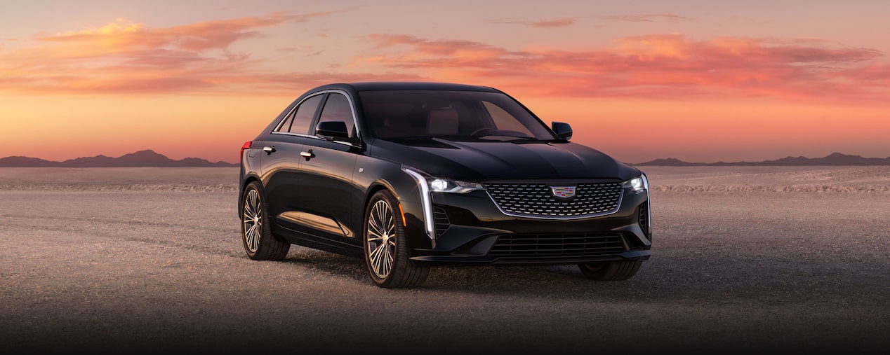 Three Quarters Front View of a Black 2025 CT4 Parked in the Open Desert