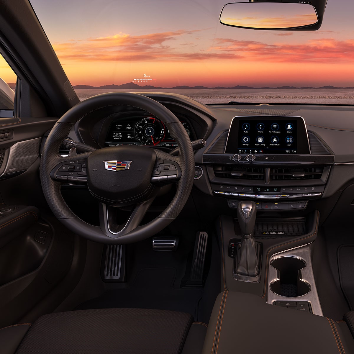 Vista del conductor de la cabina delantera de CT4 2025 con vista a una hermosa puesta de sol