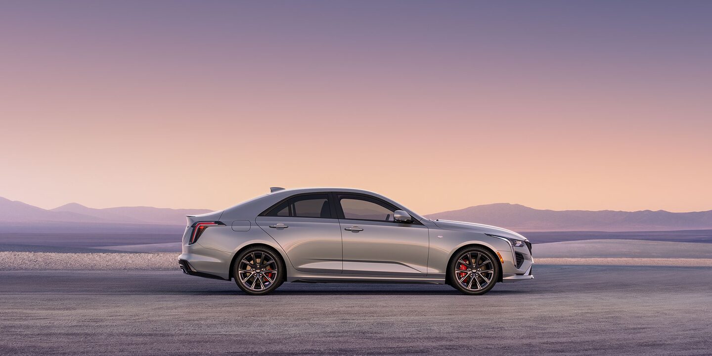Side view of Cadillac CT-4 parked on desert landscape