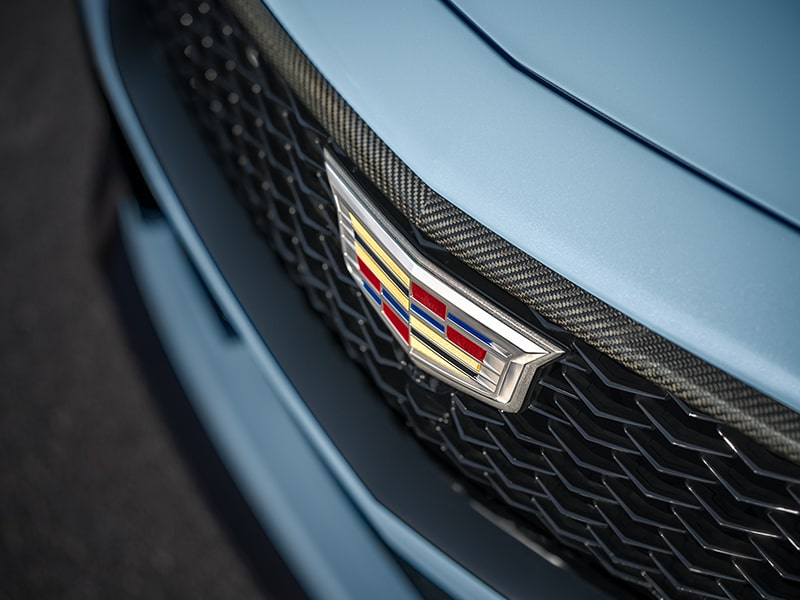 Close-up of a Cadillac Emblem on the Grill of a Light Blue 2025 CT5-V