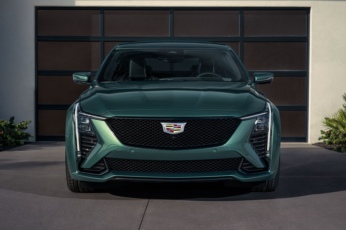 Front View of a Green 2025  Cadillac CT5-V in Front of a Closed Garage