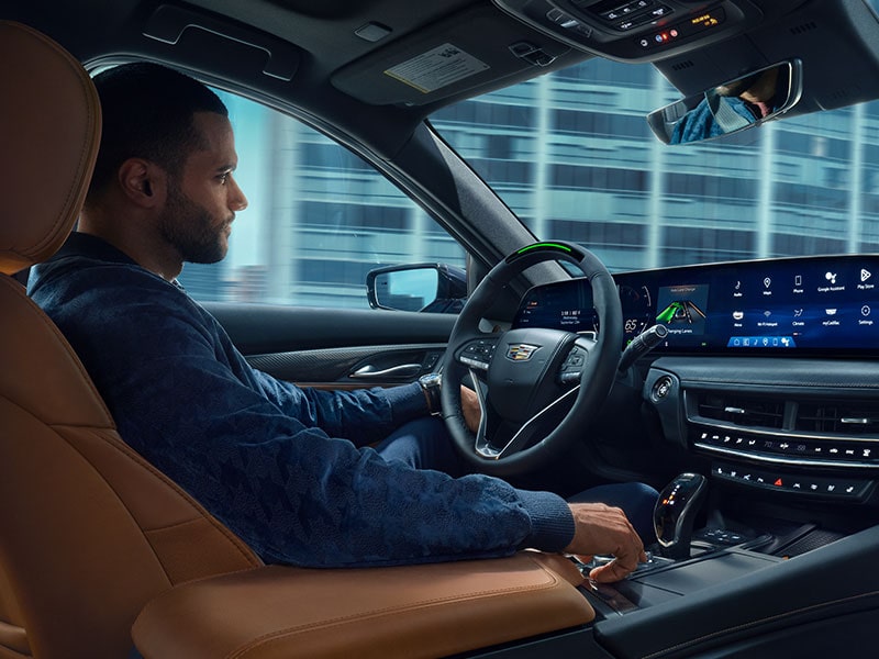 A Man Driving a 2025 Cadillac CT5 Utilizing the Super Cruise Feature