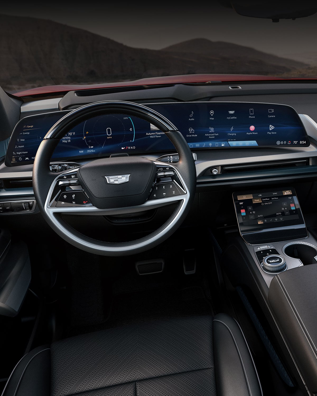 A Panoramic Interior View of a Cadillac VISTIQ's Front Row and Dashboard Outlooking the Mountains