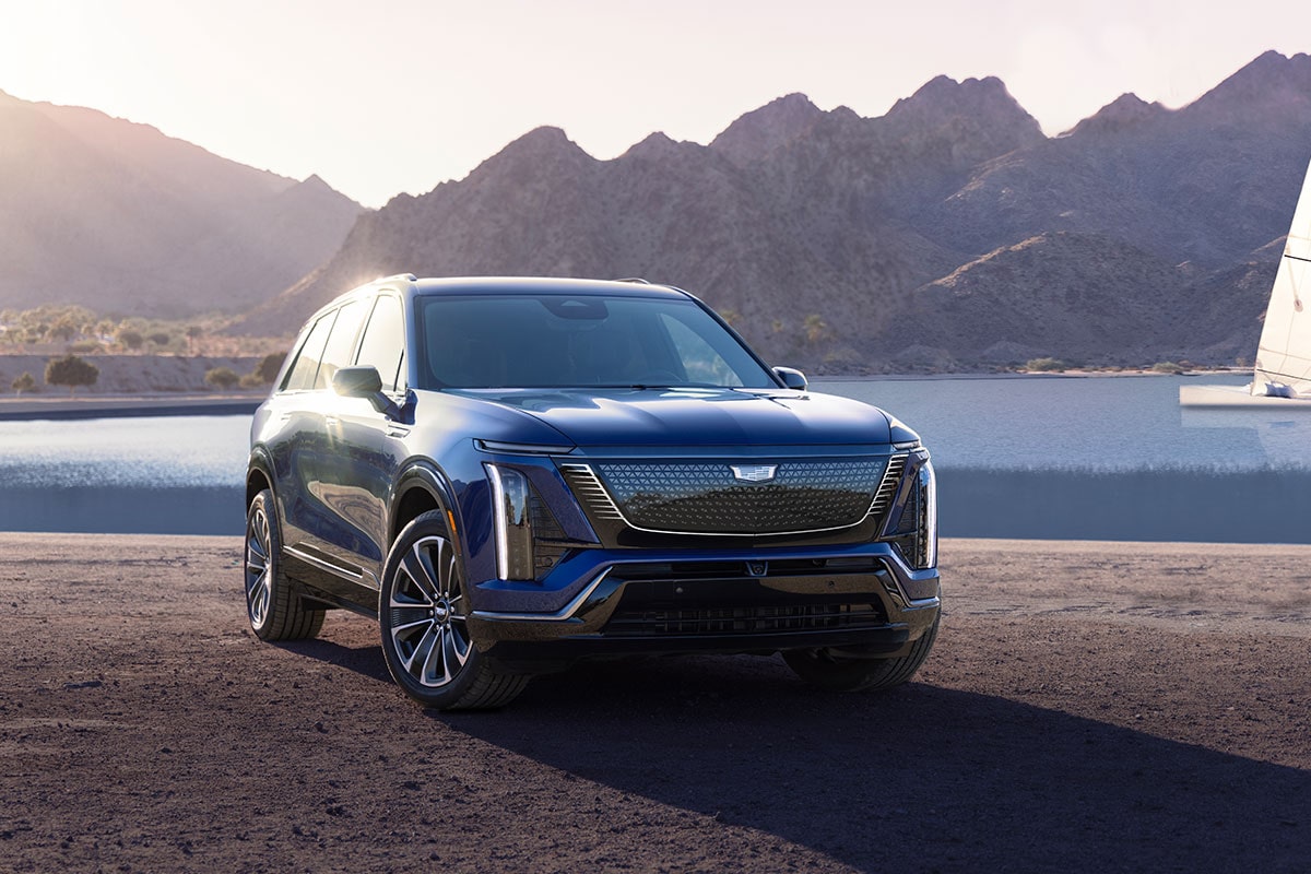 Three-quarters View of the 2026 Cadillac VISTIQ Parked Near a Lake Surrounded by Mountains