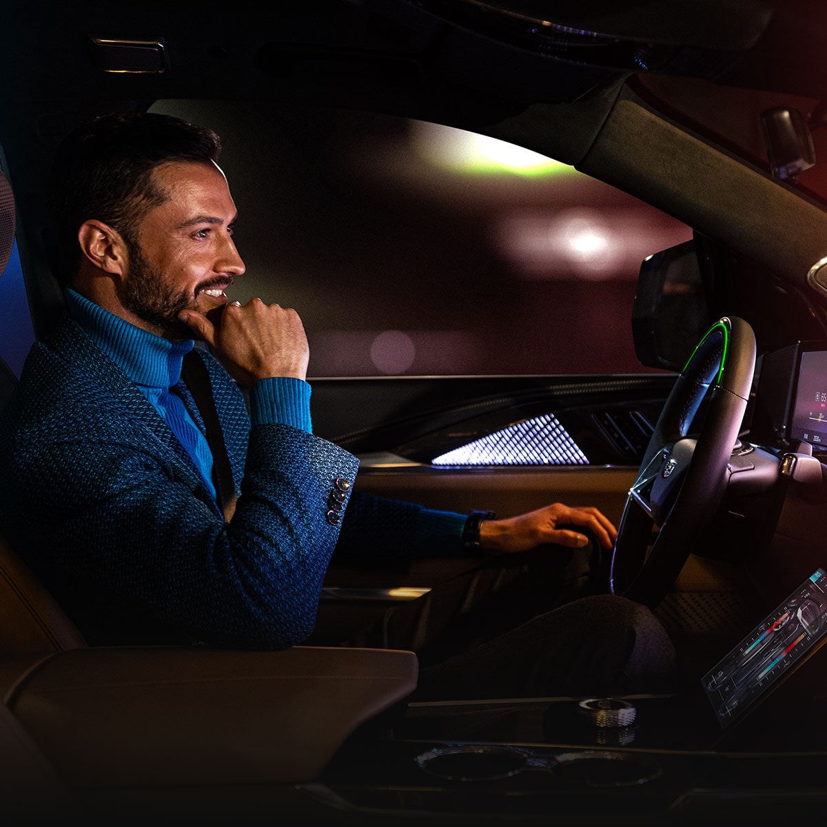 A Man Smiling While Driving Hands-free While Utilizing Super Cruise in the 2026 ESCALADE IQ