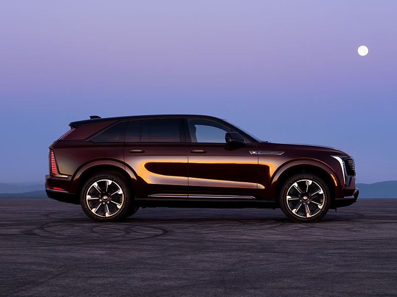The Side Profile of the 2026 ESCALADE IQ Parked in the Desert During Dusk