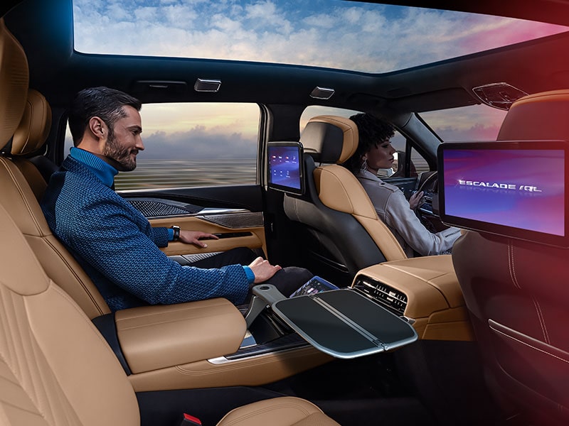 A Man in Glasses Sitting in the Second Row Captain Chair of the 2026 ESCALADE IQL Long Range EV