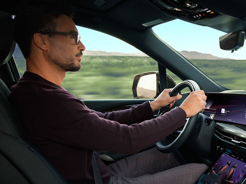 Close-up of a Man Driving the 2026 ESCALADE IQL Large Electric SUV