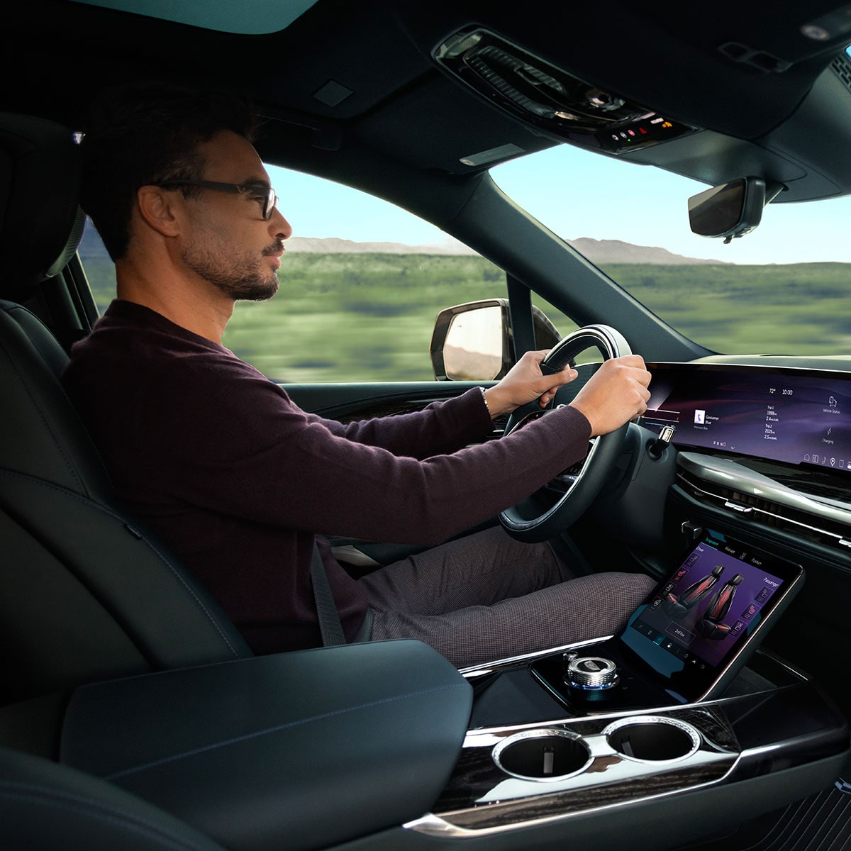 Passenger View of a Man Driving the 2026 ESCALADE IQL Large Electric SUV in the Desert