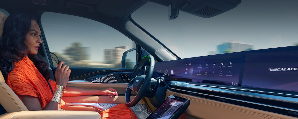 Passenger View of a Woman Driving a Cadillac with Hands Off the Steering Wheel and Utilizing the Super Cruise Feature