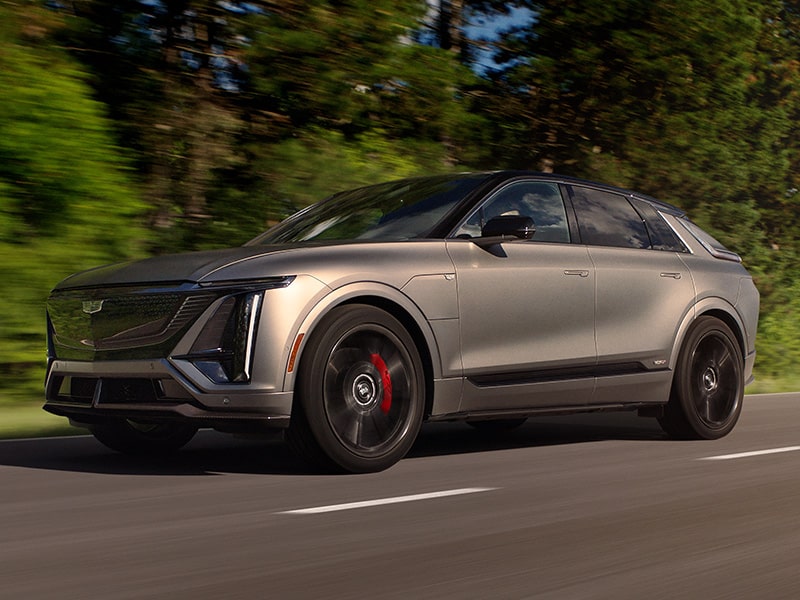 Front Driver-Side View of the 2026 Cadillac LYRIQ-V Driving Down the Road