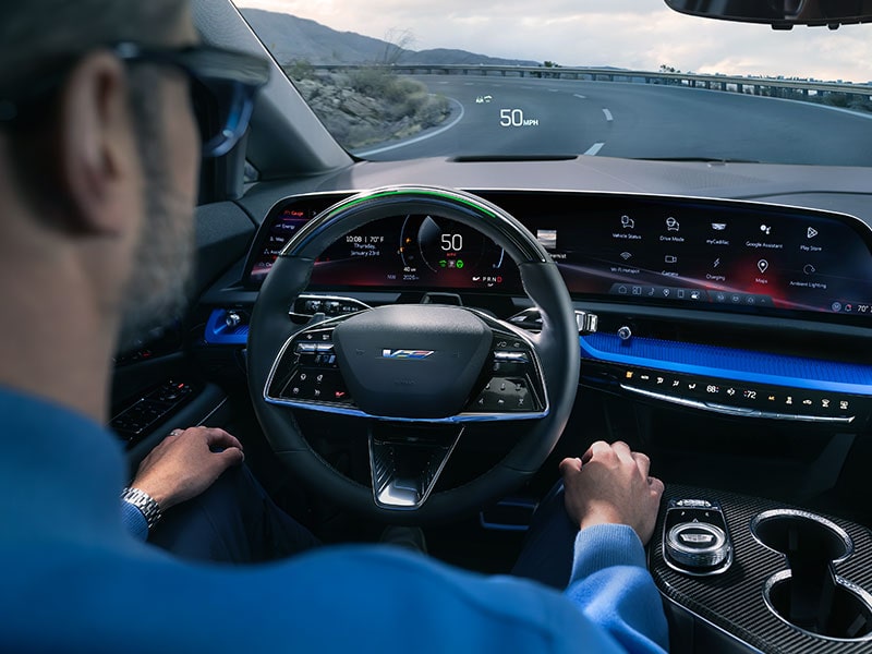 Back Seat View of a Man Driving a OPTIQ Using Super Cruise Hands-free Technology