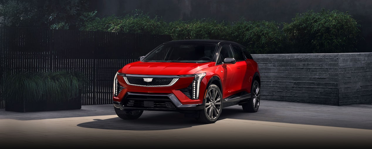 A Red 2026 Cadillac OPTIQ Parked in a Driveway