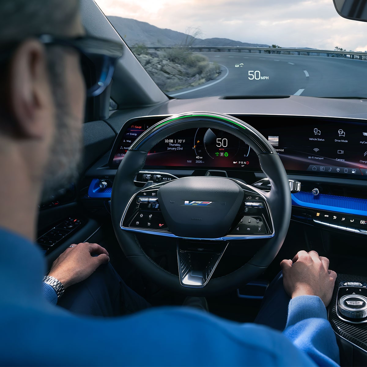 Back Seat View of a Man Driving a OPTIQ Using Super Cruise Hands-free Technology