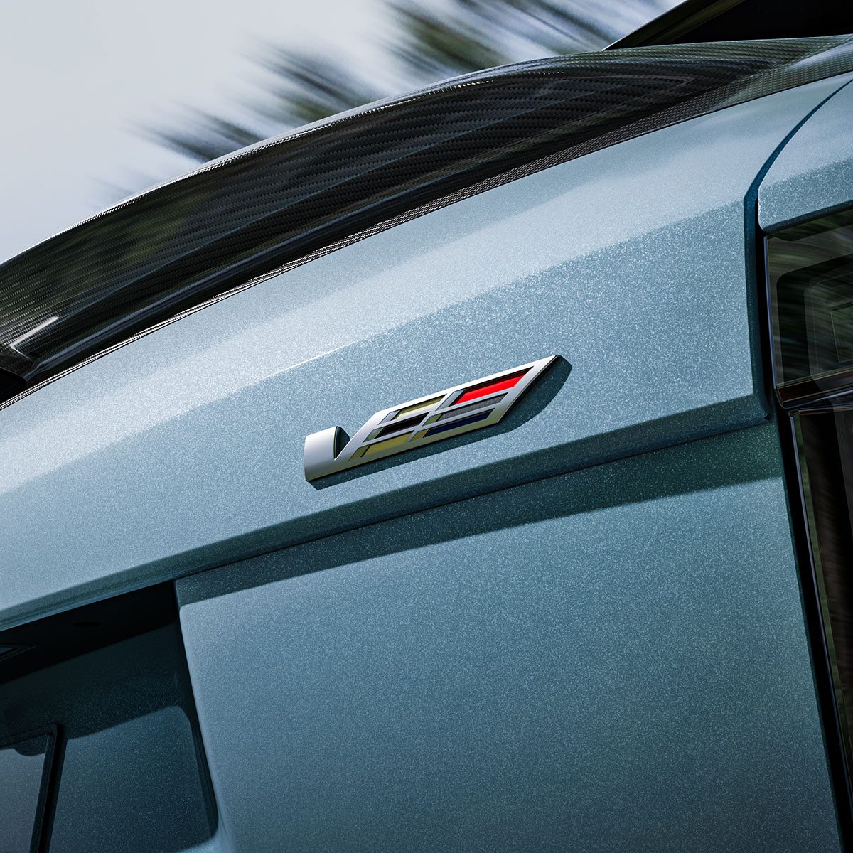 The V-Series Badge on the Rear End of a Blue 2026 OPTIQ-V