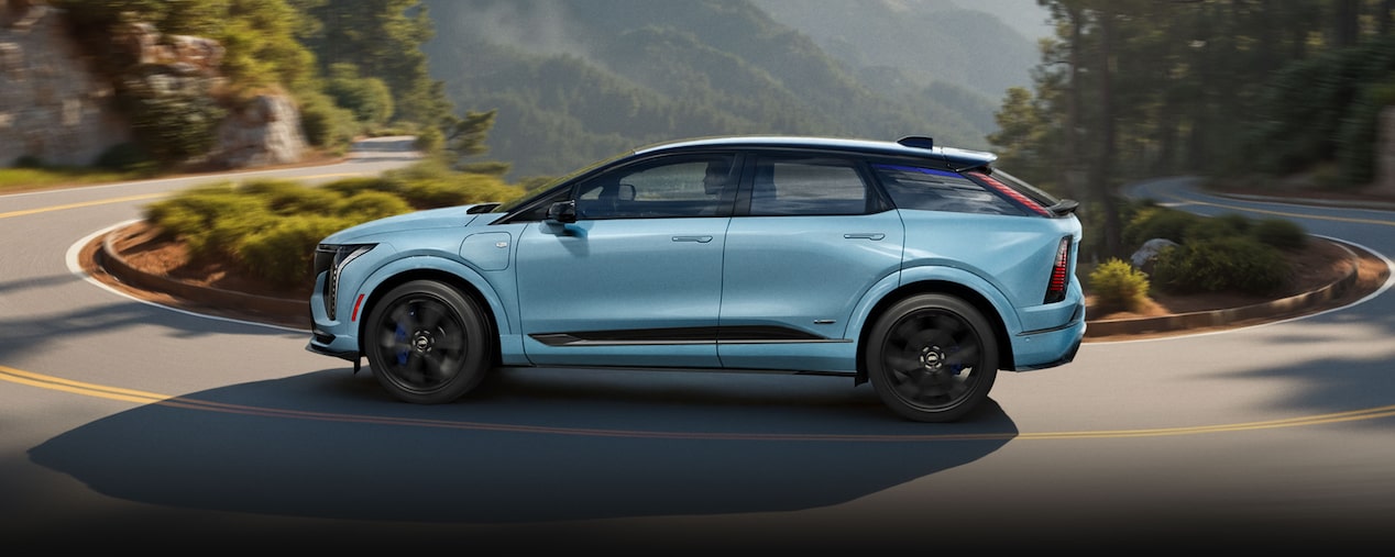 Three-quarters Passenger Side View of a Parked Blue 2026 OPTIQ-V