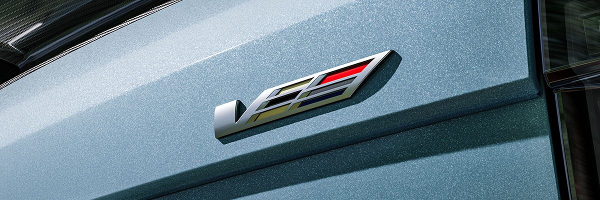 The V-Series Badge on the Rear End of a Blue 2026 OPTIQ-V