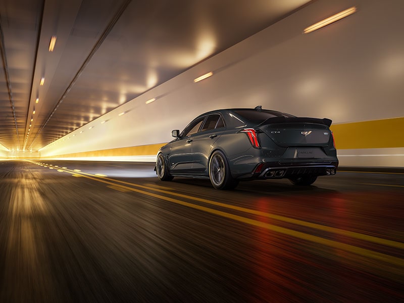 Rear View of a Yellow Cadillac CT4-V AWD Sedan Driving Through a Tunnel