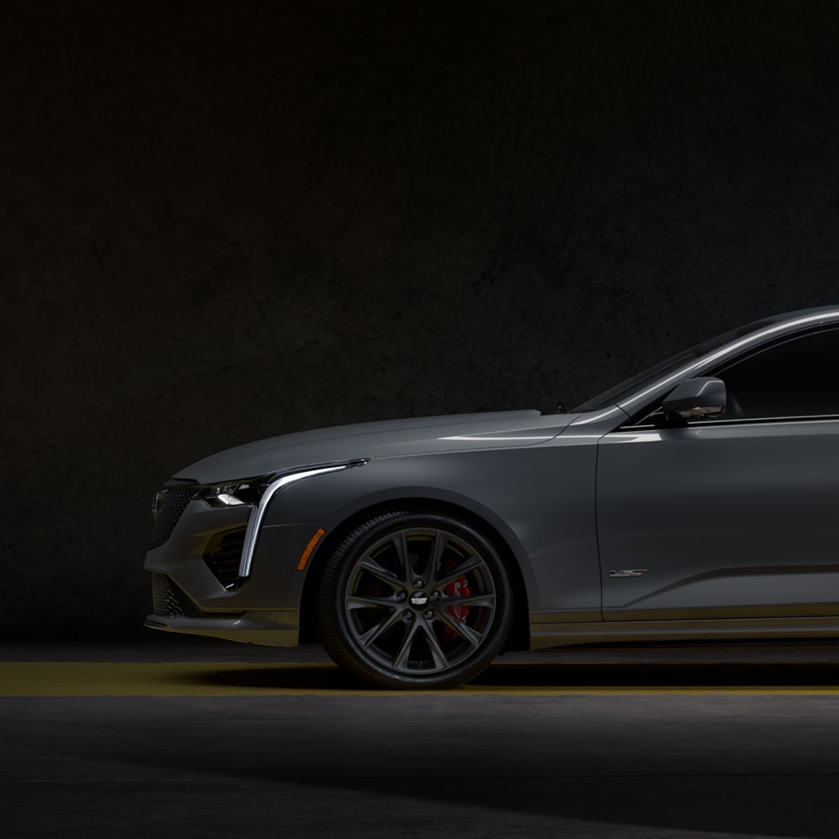 The Front Half Side Profile of a Yellow CT4-V Driving Past Mountains