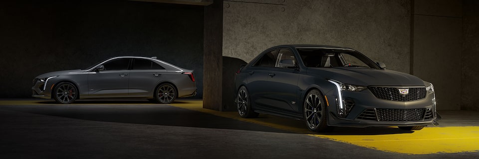 A Silver CT4-V and a Yellow CT4-V Blackwing Parked in a Parking Garage