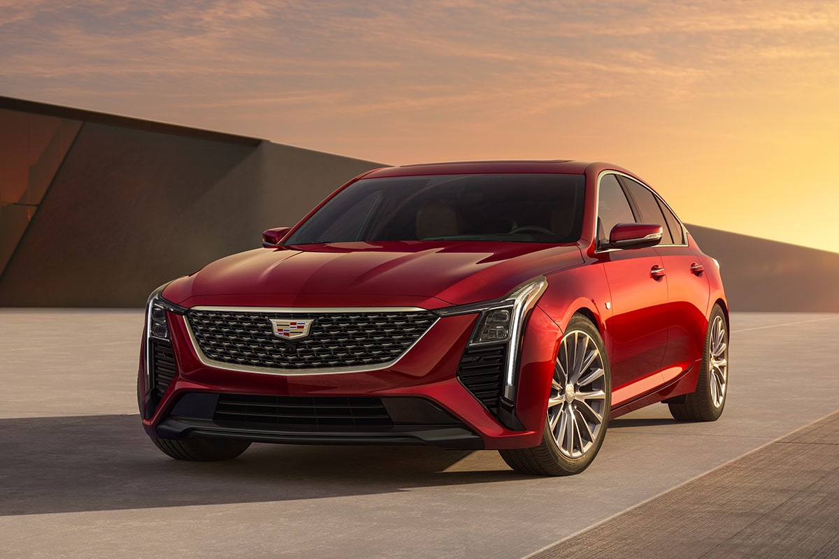 Front Driver's Side View of Parked Red 2026 Cadillac CT5 With Beautiful Sun Setting Displayed