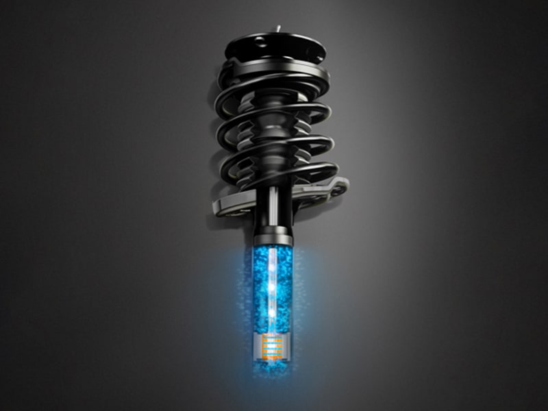 The 2026 Cadillac Escalade Suspension Part on Gray Background