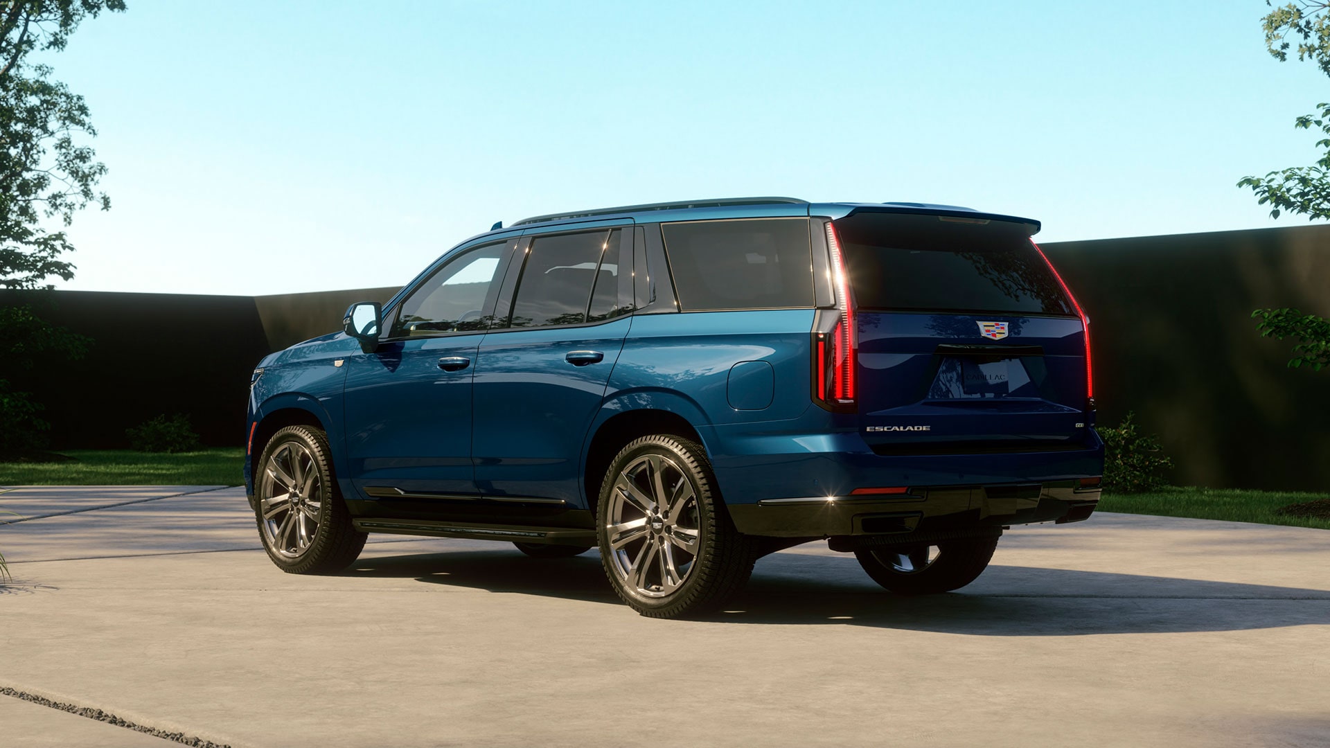 Three-Quarter Rear View of a Blue 2026 Cadillac Escalade Parked in a Driveway