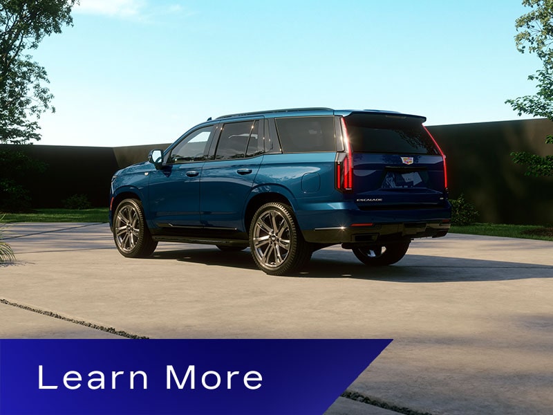 Three-Quarter Rear View of a Blue 2026 Cadillac Escalade Parked in a Driveway