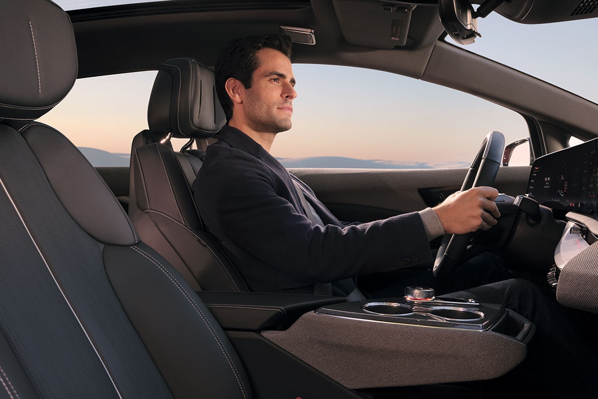 Passenger View of a Man Driving a 2027 Cadillac OPTIQ