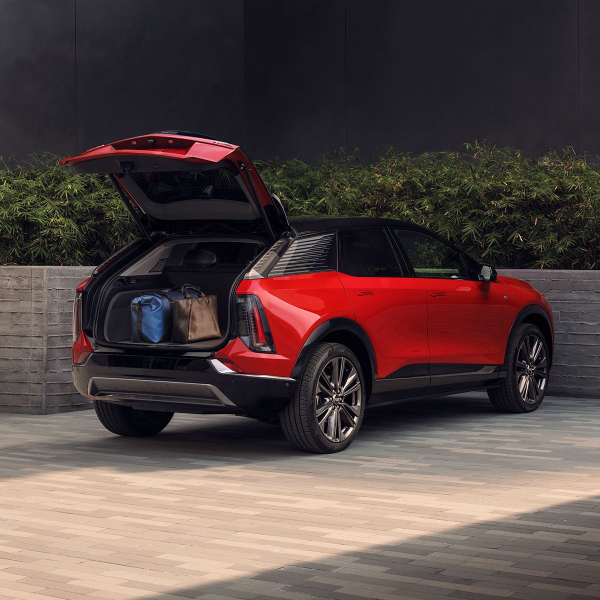 Back Three-quarter View of the 2027 Cadillac OPTIQ Trunk Open with Cargo Loaded Inside