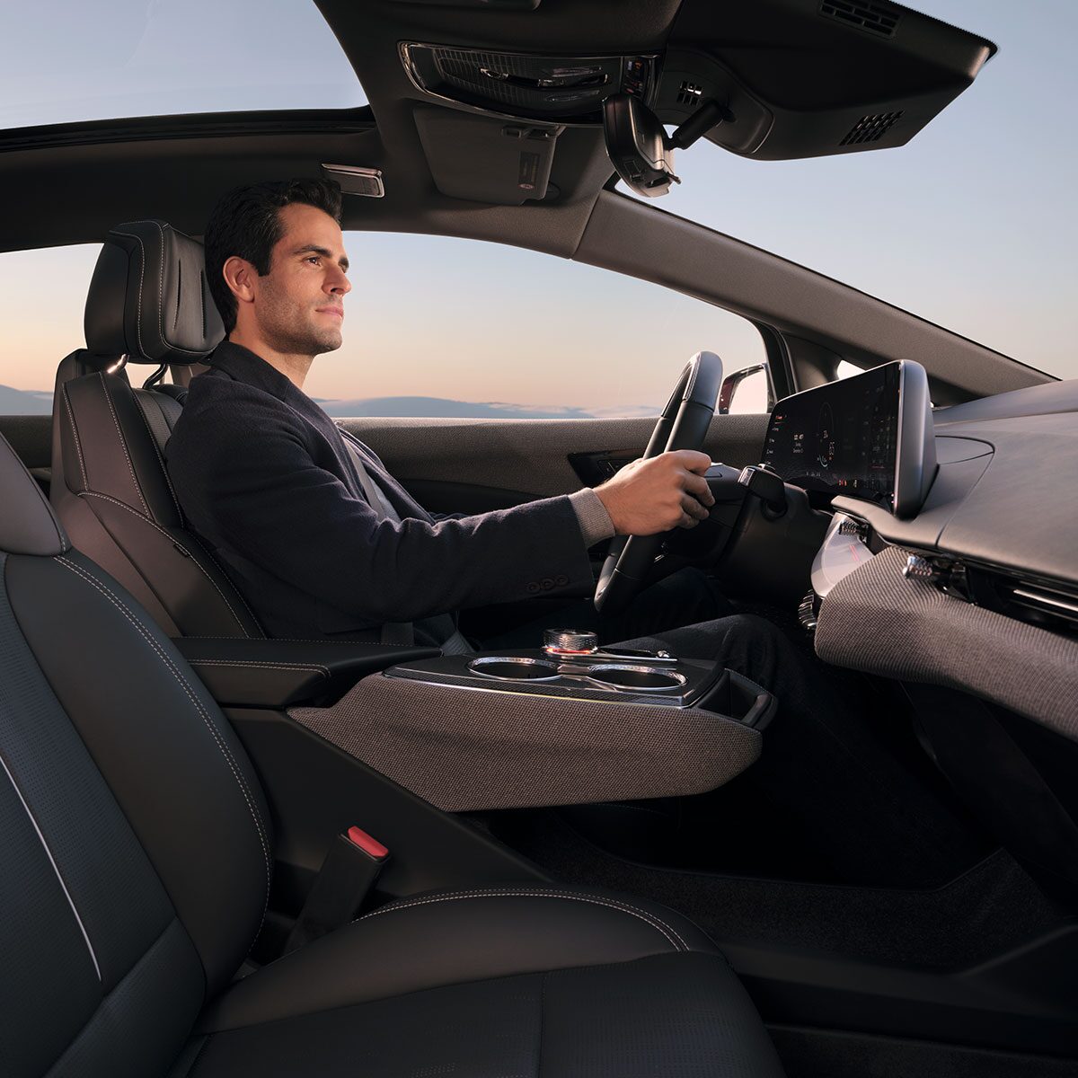 Passenger View of a Man Driving a 2027 Cadillac OPTIQ