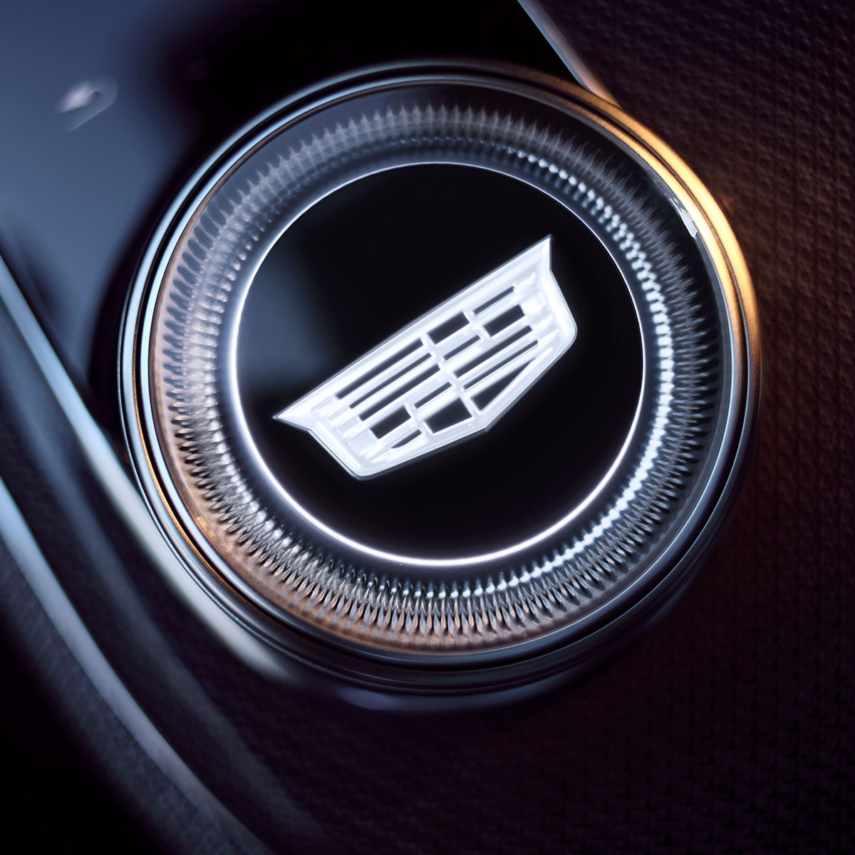 Close-up of the 2027 Cadillac OPTIQ Gear Knob with a Cadillac Logo in the Center