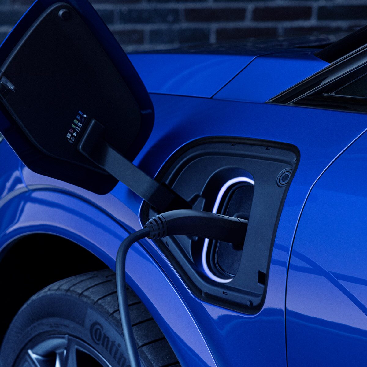 Close-up of a Charger in the EV Port of a Blue OPTIQ-V