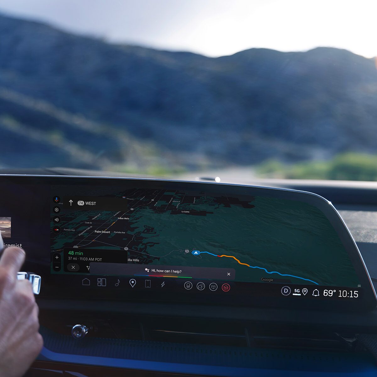 Close-up of Someone Driving the 2027 OPTIQ-V and Utilizing the Navigation on the Display Screen