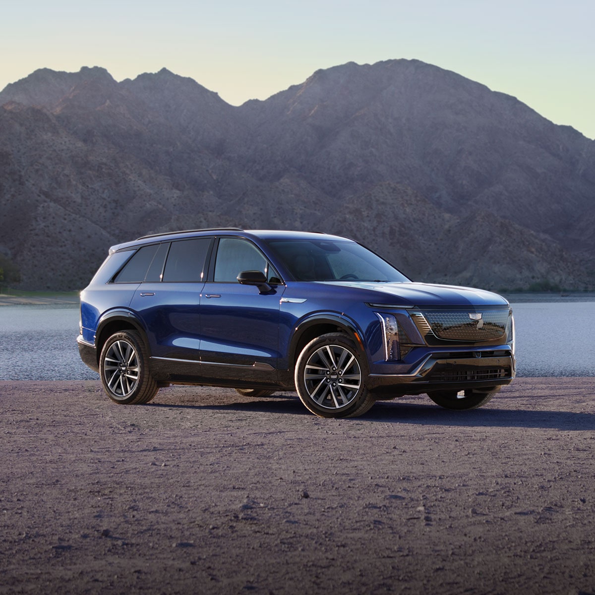 Three-quarter View of a Blue 2027 VISTIQ Parked on a Asphalt Surface Outlooking the Mountains