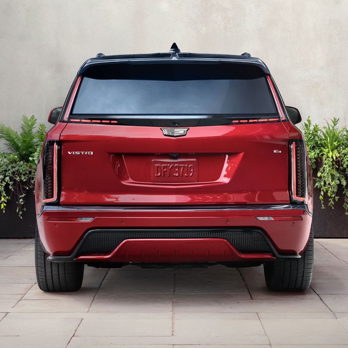 Rear View of a Red 2027 VISTIQ Parked on a Concrete Driveway