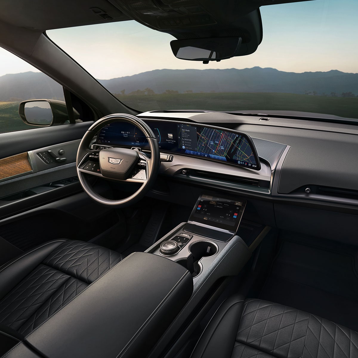 A Panoramic Interior View of a Cadillac VISTIQ's Front Row and Display Screen Utilizing Google Built-In Compatibility with Navigation