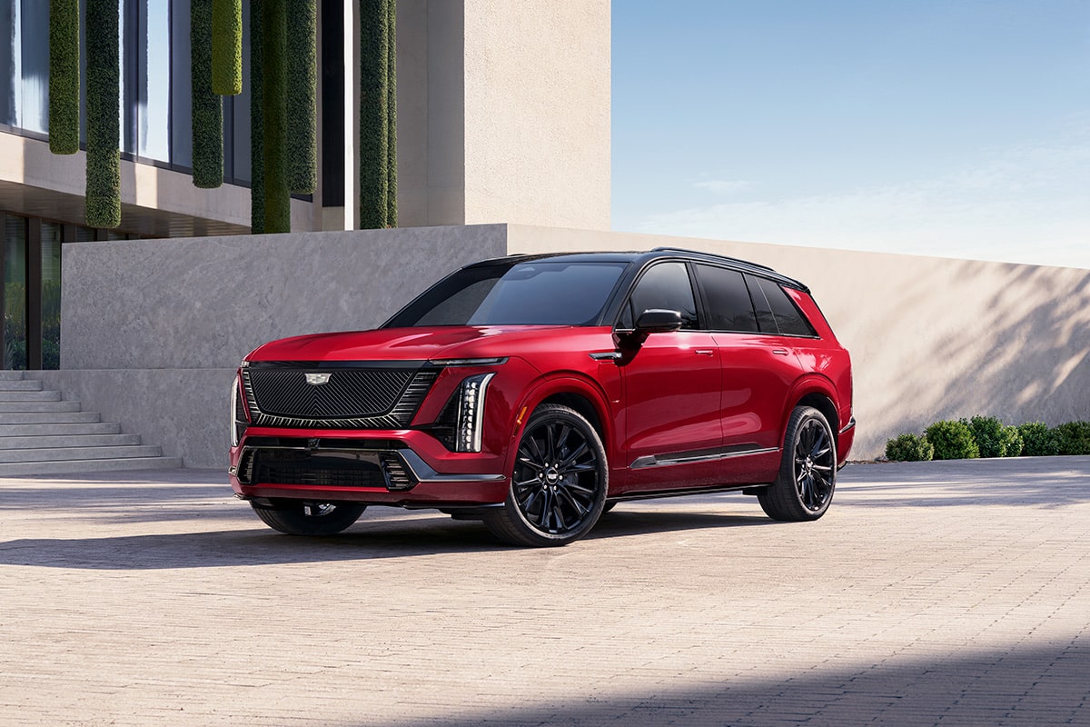 Three-quarters View of a 2027 VISTIQ 3-row Electric SUV Parked near a Concrete Wall