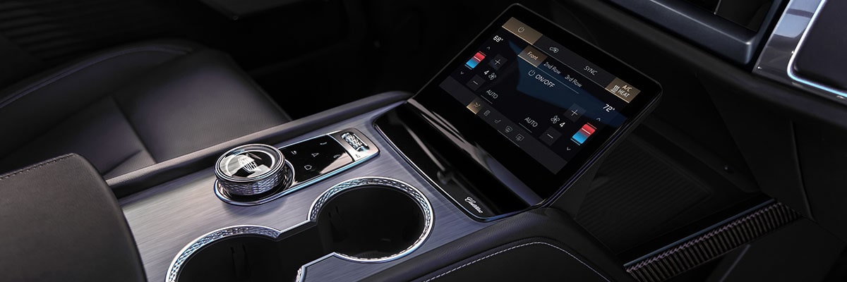 Close-up of the 2027 Cadillac VISTIQ Middle Console Including the Cup Holders, Gear Knob and Climate Control Screen