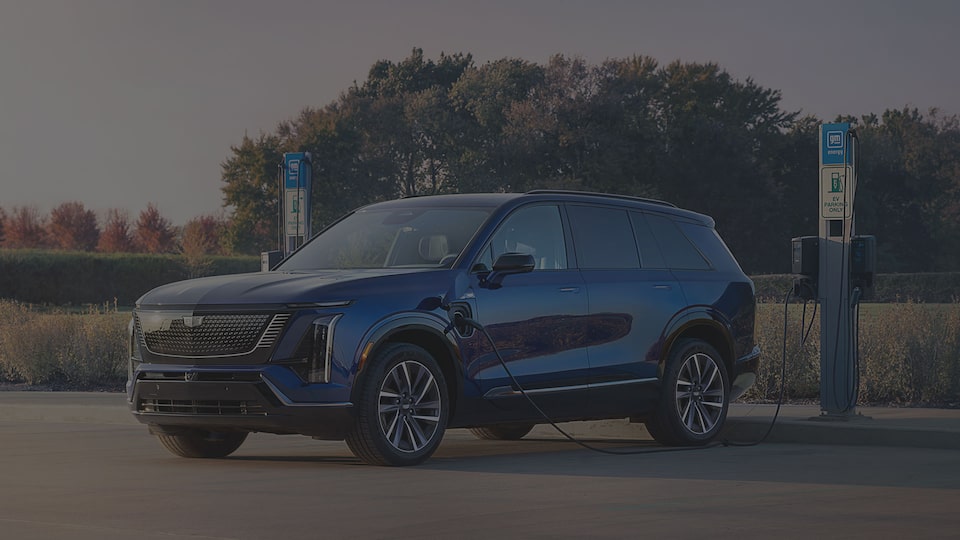 Three-quarter View of a Cadillac VISTIQ Parked and Charging at a Public Charger